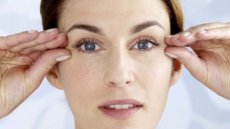 Une femme tient ses mains près de ses yeux